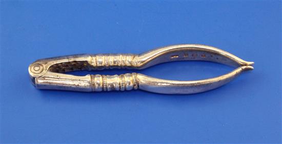 A pair of George V silver nut crackers by Collins & Co, (Dryad Art Metal Works), 2 oz.